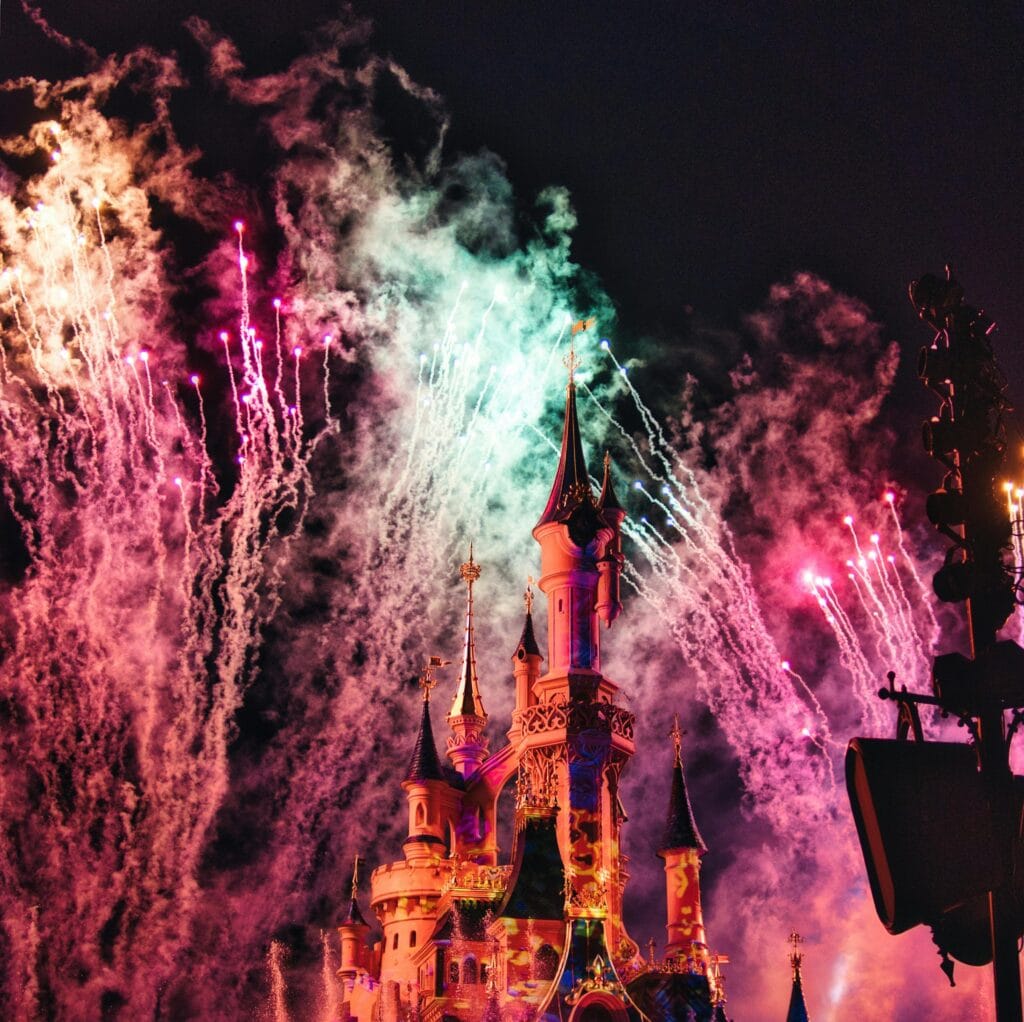 Fireworks light up the night sky over Sleeping Beauty Castle at Disneyland Paris, one of the top day trips from paris
