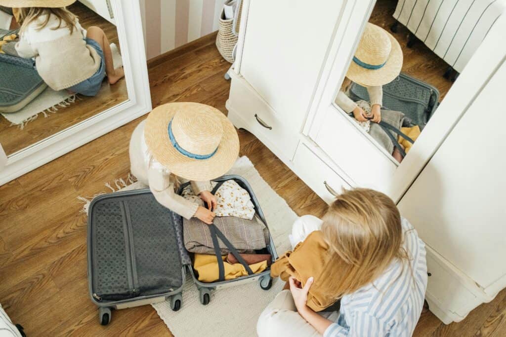 Mom and child packing a suitcase for their Paris family vacation — perfect visual for a family-friendly Paris packing list.